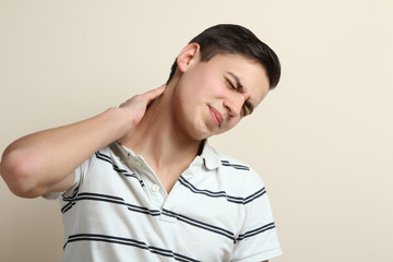 Young man experiencing neck pain.