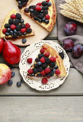 Piece of fruit tart with blackberries, raspberries and blueberri
