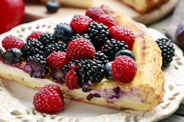 Piece of fruit tart with blackberries, raspberries and blueberri