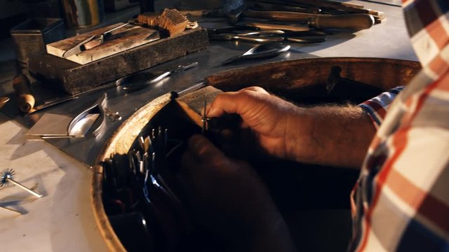 Attentive goldsmith working in workshop 4k