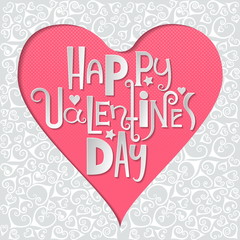 Concept for greeting card on Valentine's Day 14 February. Heart cut out from decorative paper and white letters of different styles inside on pink background.