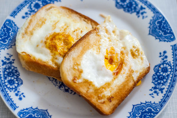 A plate of golden brown french toast. Eggy bread on the plate