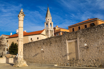Pillar of shame and St.Elias's church on the Roma Capitolium in Zadar. Croatia.