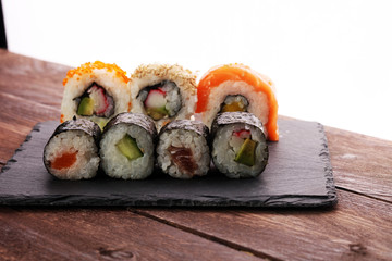 close up of sashimi sushi set with chopsticks and soy - sushi roll with salmon and sushi roll with smoked eel, selective focus.