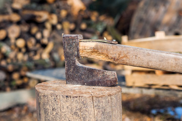 chopping wood with ax. Ax stuck in a log of wood. Old, worn, 