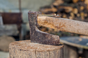 chopping wood with ax. Ax stuck in a log of wood. Old, worn, 
