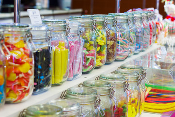 the counter in the store with candy in glass jars