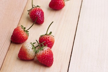 Ripe strawberries on wooden table with sweet tone