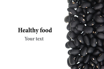 Border of black  kidney beans closeup with copy space on white background. Isolated. Healthy protein food.