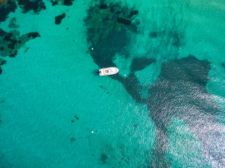 Aerial  view of a boat mooring in translucent turquoise water