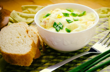 Microwave baked eggs, sausages and cheese with choped spring onion served on the checkered napkins