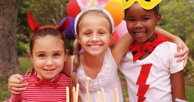 Kids in various costumes celebrating birthday in the park 4k