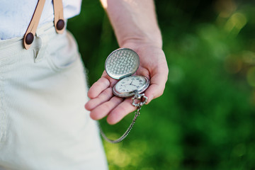 Vintage retro watches on hand of old fashioned man.