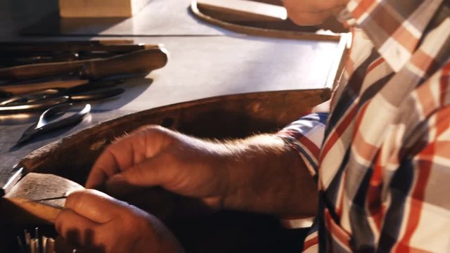 Attentive goldsmith working in workshop 4k