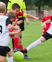 Fototapeta premium Boys kicking ball