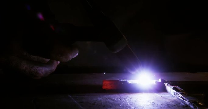 Close-up of welder using welding torch in workshop 4K