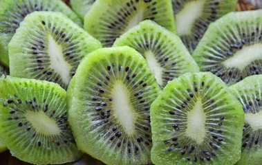 bright green background of slices of kiwi, cut kiwi, juicy pulp kiwi, green