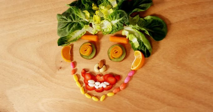 Face made up of vegetable and confectionery on a table 4k