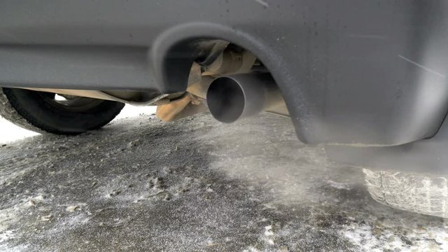Toxic gases are exhausted on the tailpipe of a car,