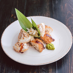 sushi on a black wooden surface