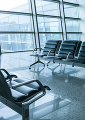 empty airport terminal waiting area with chairs