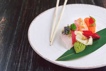 sushi on a black wooden surface