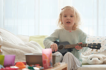 kleines blondes mädchen mit gitarre