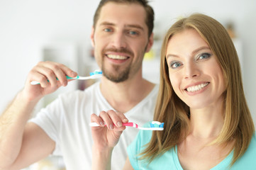 young couple brushing their teeth