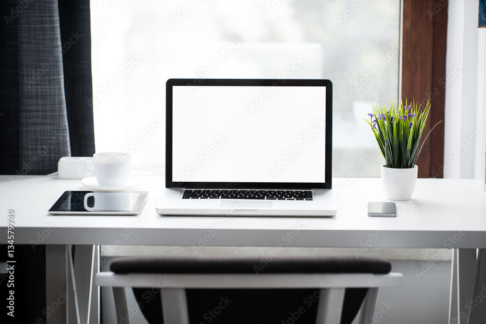 Wall mural Laptop on a wooden table with isolated screen