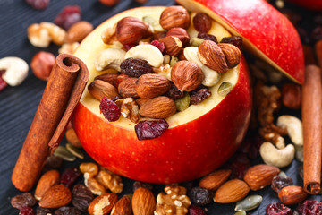 Red juicy apple with assorted nuts , raisins and cinnamon
