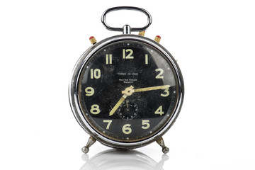 Old vintage alarm clock isolated on white..