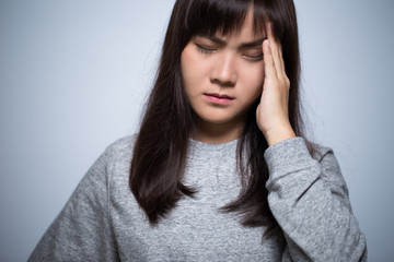 Woman has head ache on isolated background