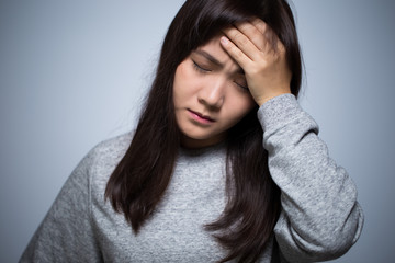 Woman has head ache on isolated background