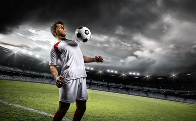 Football player withstand a ball with his chest in the stadium © efks