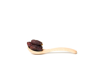 A dried dates in a wooden spoon isolated over white background