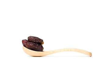 A dried dates in a wooden spoon isolated over white background