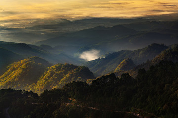Landscape in Doi Ang Khang Chiang Mai Thailand with misty morning sunrise over mountains.