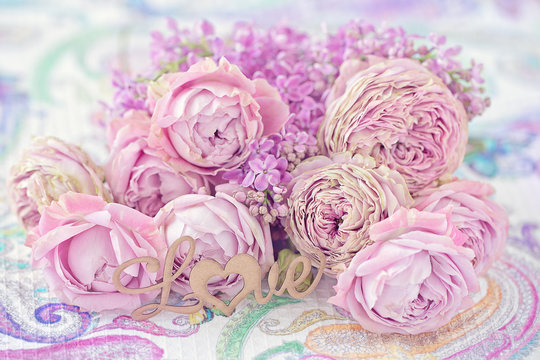 Lovely bunch of flowers .Close-up floral composition with a pink roses on a table. Beautiful bouquet for a birthday or Valentine's Day.Congratulation with a flowers . 