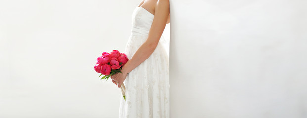 young bride holding peony bouquet