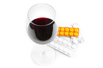Glass Of Wine And Pills On White Background