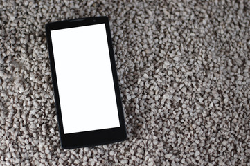 smartphone in sand isolated screen
