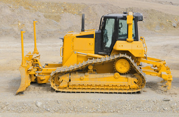 Yellow bulldozer on construction site