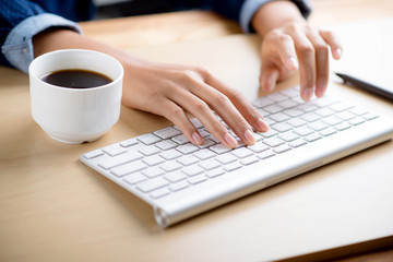  Hands on keyboard and coffee cup