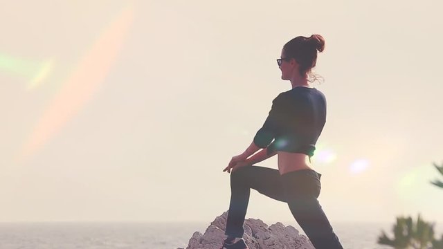 Young Woman Silhouette Yoga On The Beach At Sunset