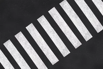 Fotobehang Topview photo of a pedestrian crossing in a street, white zebras on asphalt road top view © Delphotostock