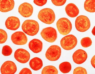 Backlit slices of red tomato, abstract textured background