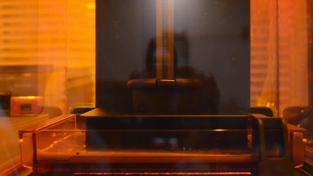 Print 3D printer detail of photopolymer general view, close. Stereolithography 3D printer, modern and progressive additive manufacturing technology of liquid photopolymerization under UV light