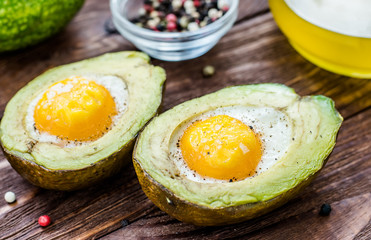 Cooked avocado with egg, pepper and salt