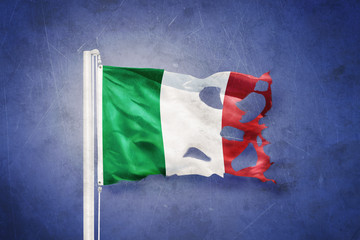 Torn flag of Italy flying against grunge background