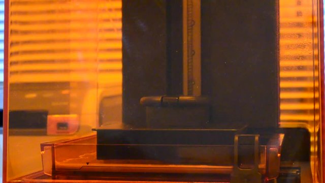 Print 3D printer detail of photopolymer general view, close. Stereolithography 3D printer, modern and progressive additive manufacturing technology of liquid photopolymerization under UV light